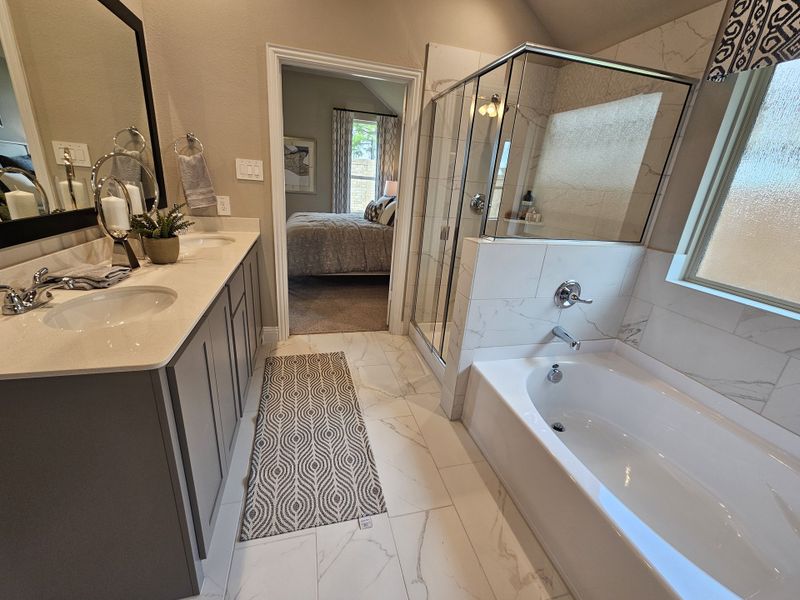 A modern bathroom with a spacious tub, dual sinks, and sleek tiled shower, offering a tranquil retreat. A modern bathroom with a spacious tub, dual sinks, and sleek tiled shower, offering a tranquil retreat.
