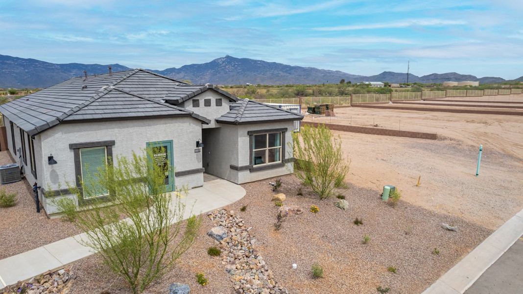 Front exterior of a home in the The Oasis at Rocking K community, located in Vail, AZ (Image 14).