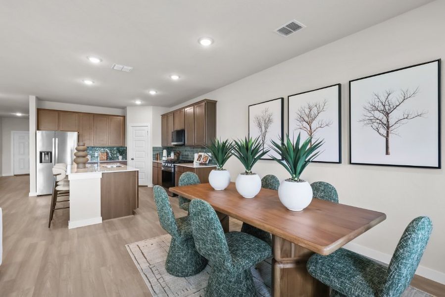 A kitchen with a dining table and chairs. A kitchen with a dining table and chairs.