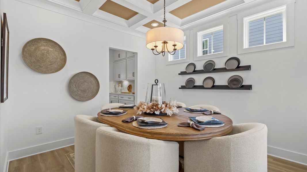 Thoughtful design meets architectural elegance in this coffered ceiling dining room