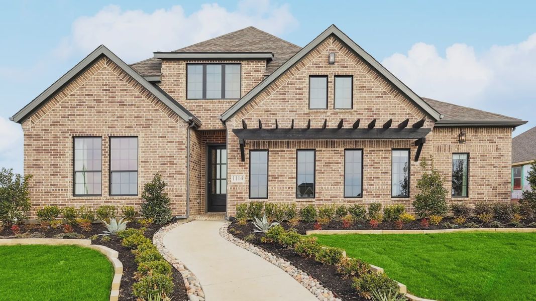 Experience refined elegance with brick exterior, expansive windows, in Westside Preserve.