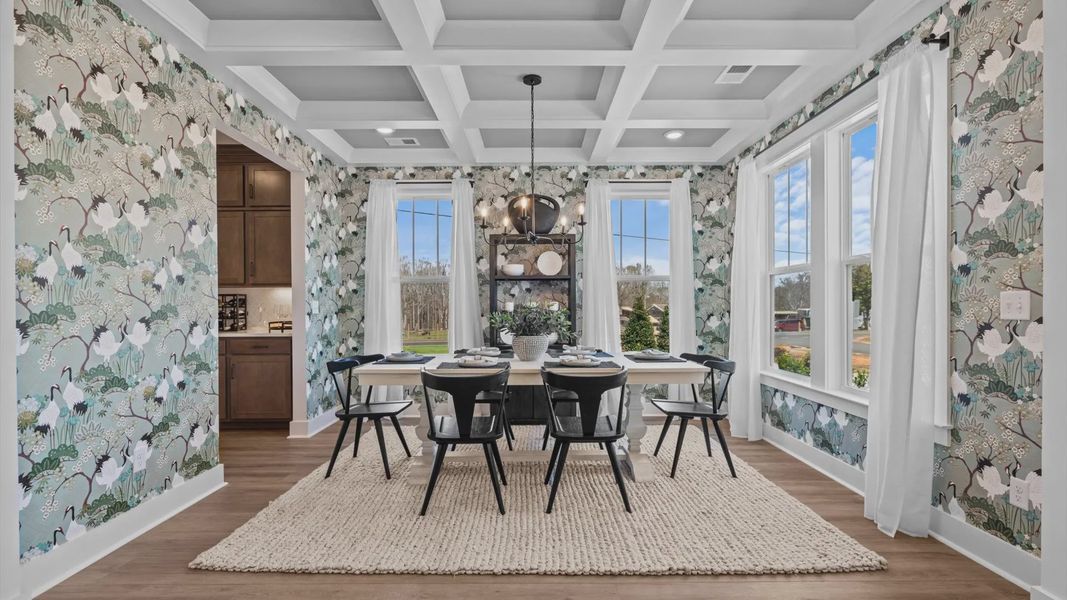 Coffered ceiling dining room with light blue accents and calming wallpaper at Pinebrook by DRB Homes in Woodruff, SC Coffered ceiling dining room with light blue accents and calming wallpaper at Pinebrook by DRB Homes in Woodruff, SC