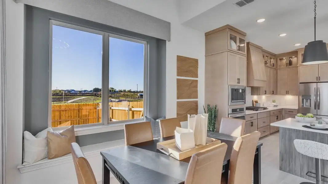 Elegant wood cabinetry and expansive window seating enhance this Creeks Crossing home.