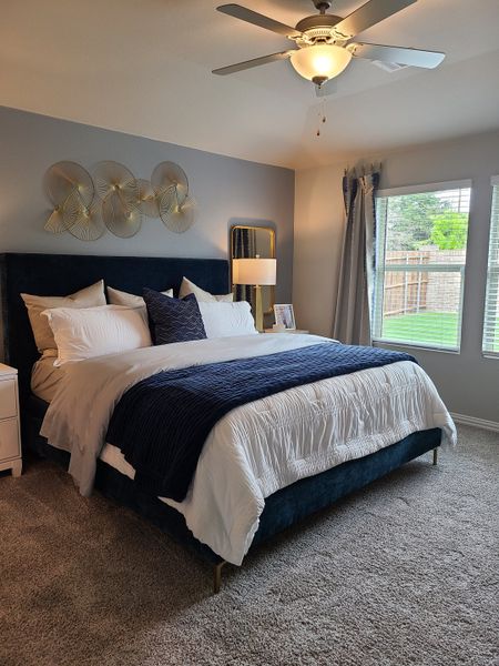 A cozy bedroom featuring a plush bed, modern decor, and soft lighting, creating a serene and inviting atmosphere.