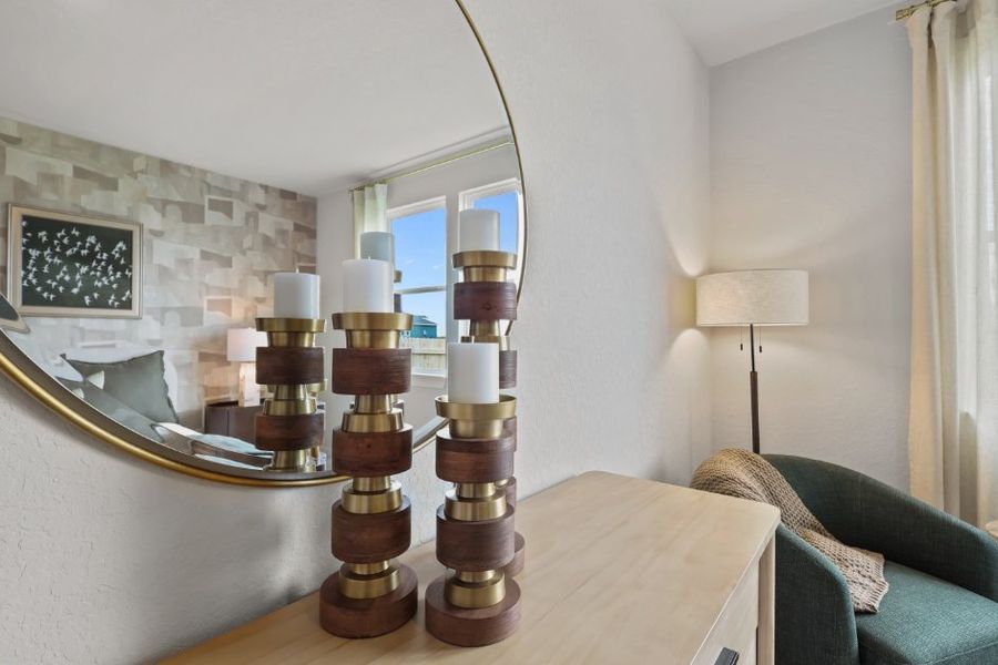 A table with a mirror and a lamp on it. A table with a mirror and a lamp on it.