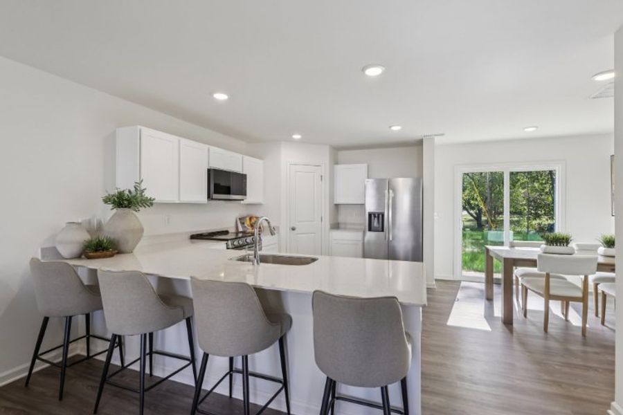 A kitchen with a dining table and chairs. A kitchen with a dining table and chairs.