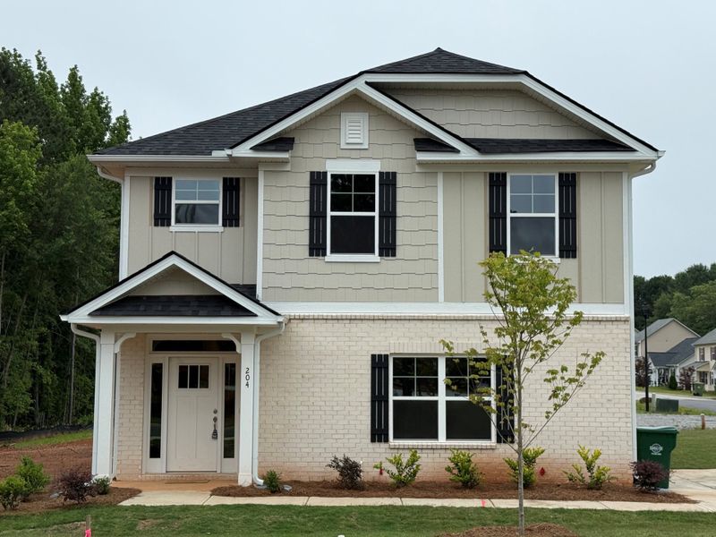 Front exterior of a home in the Canterbury Villas community, located in Carrollton, GA (Image 1).