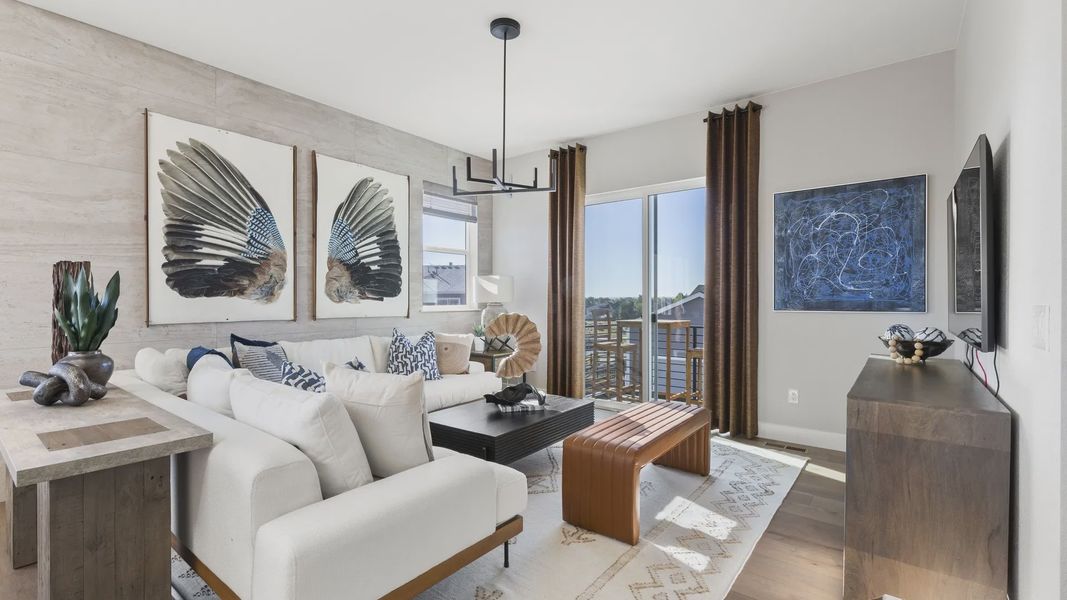 Sophisticated living room featuring floor-to-ceiling windows and chic modern art in Dillon Pointe. Sophisticated living room featuring floor-to-ceiling windows and chic modern art in Dillon Pointe.