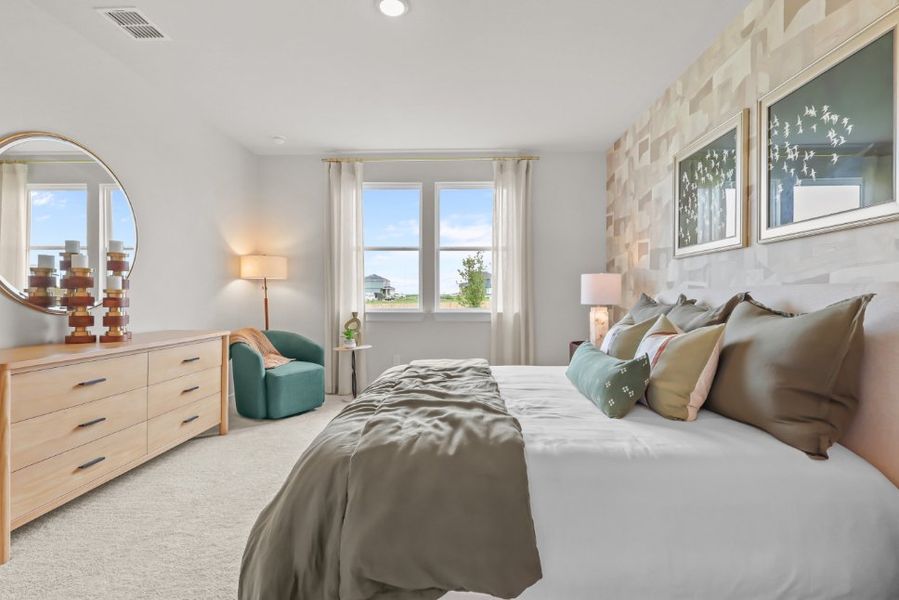 A bedroom with a bed and a mirror. A bedroom with a bed and a mirror.
