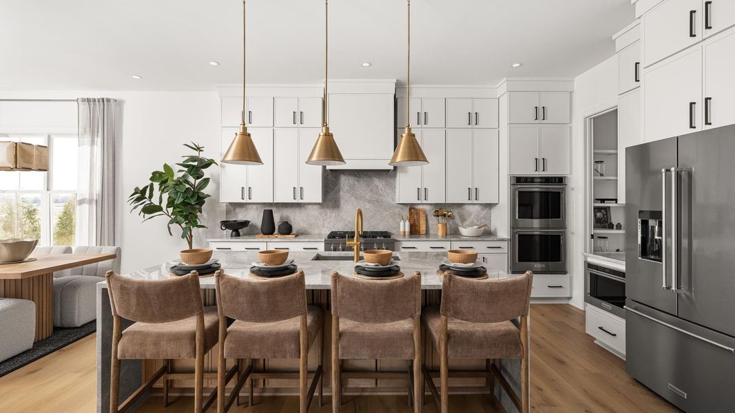 Gourmet kitchen boasts a large center island and stainless steel appliances