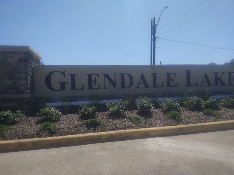 A welcoming entrance with lush landscaping at Glendale Lakes North by KB Home in Arcola, TX.