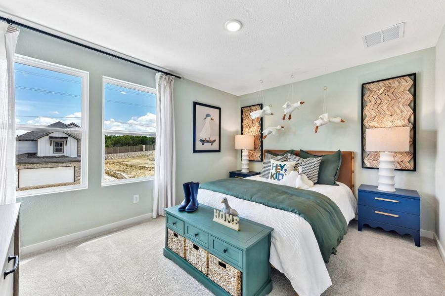 A bedroom with a blue bed.
