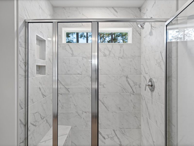 The primary ensuite boasts duel sinks, tile shower and large walk-in closet.