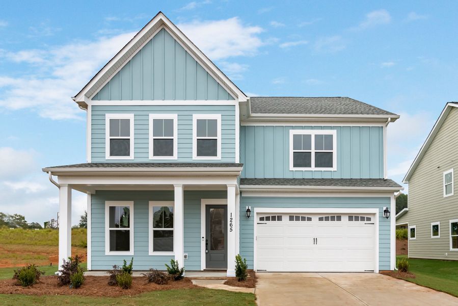 This Master-Up plan includes a main floor Guest Suite with a private bath, 10' ceilings down, and 9' ceilings up. The kitchen features quartz countertops, a large island with a farmhouse sink, and opens to the living room with adjacent outdoor patio.