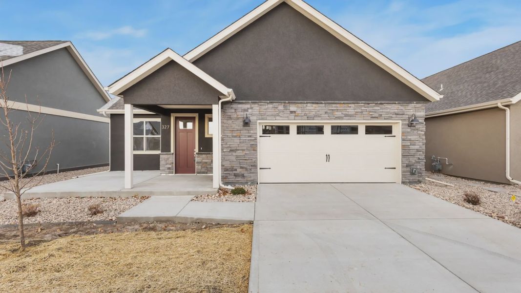 Front exterior of a home in the The Courtyards at Lupton Village community, located in Fort Lupton, CO (Image 2).