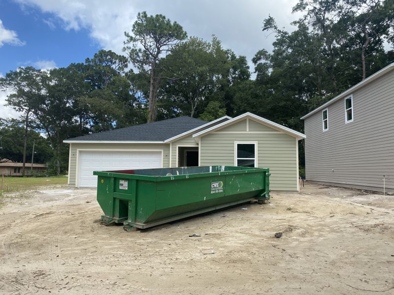 A modern single-story home under construction in Whistler Woods by Lennar in Jacksonville, FL, featuring a spacious garage.