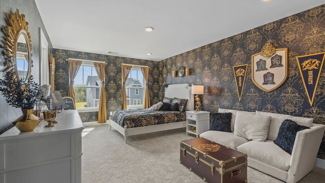 Harry Potter themed secondary bedroom with plush carpet and large windows at Woodglen by DRB Homes