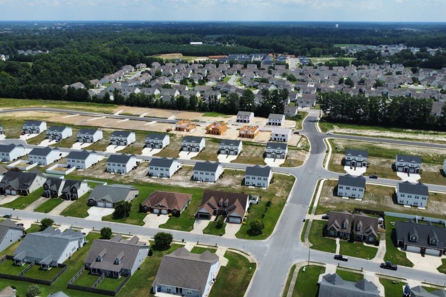 A group of houses in a field. A group of houses in a field.