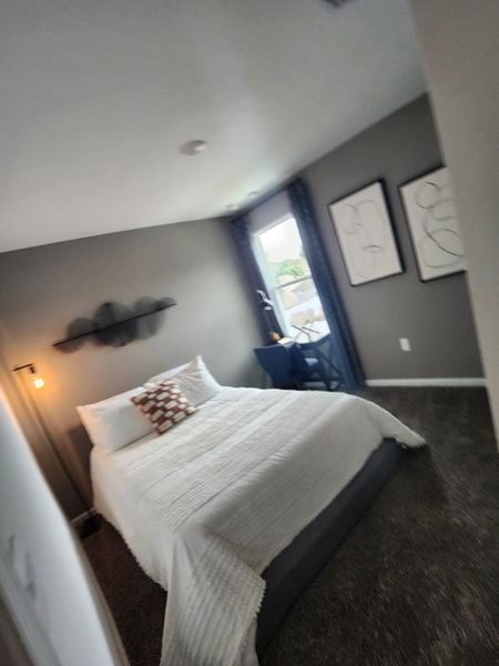 A cozy bedroom featuring a plush bed, modern art, and soft lighting, creating a tranquil retreat. A cozy bedroom featuring a plush bed, modern art, and soft lighting, creating a tranquil retreat.