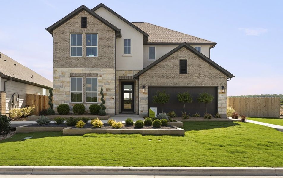 Front exterior of a home in the Lagos Reserve community, located in Manor, TX (Image 2).