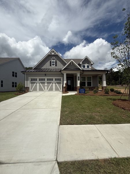 A charming craftsman home with gable details and a lush yard in Twelve Parks 55+ by Lennar (Sharpsburg, GA).