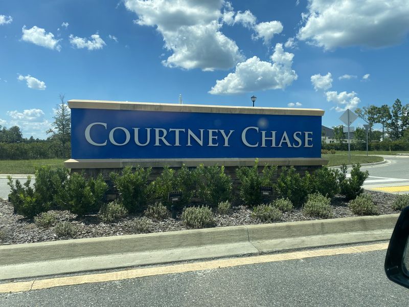 A community sign for Courtney Chase, surrounded by lush greenery in Courtney Grove at SilverLeaf by ICI Homes (St. Augustine, FL).
