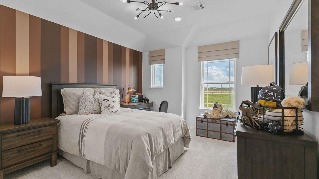 Luxurious River Ranch bedroom features a designer chandelier and bold striped wall, offering elegance. Luxurious River Ranch bedroom features a designer chandelier and bold striped wall, offering elegance.