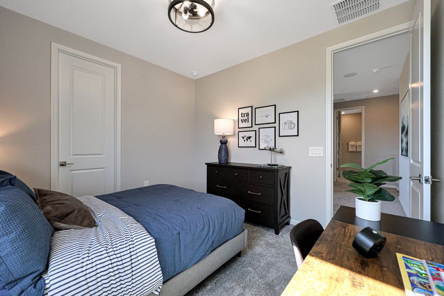 A bedroom with a bed and a table. A bedroom with a bed and a table.