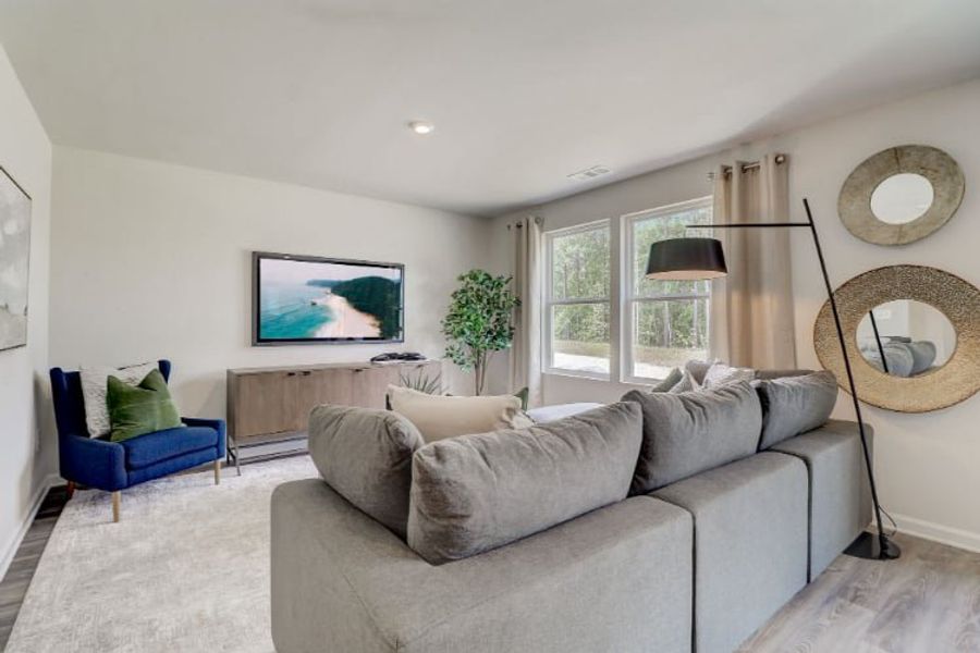 A living room with a couch and a tv. A living room with a couch and a tv.