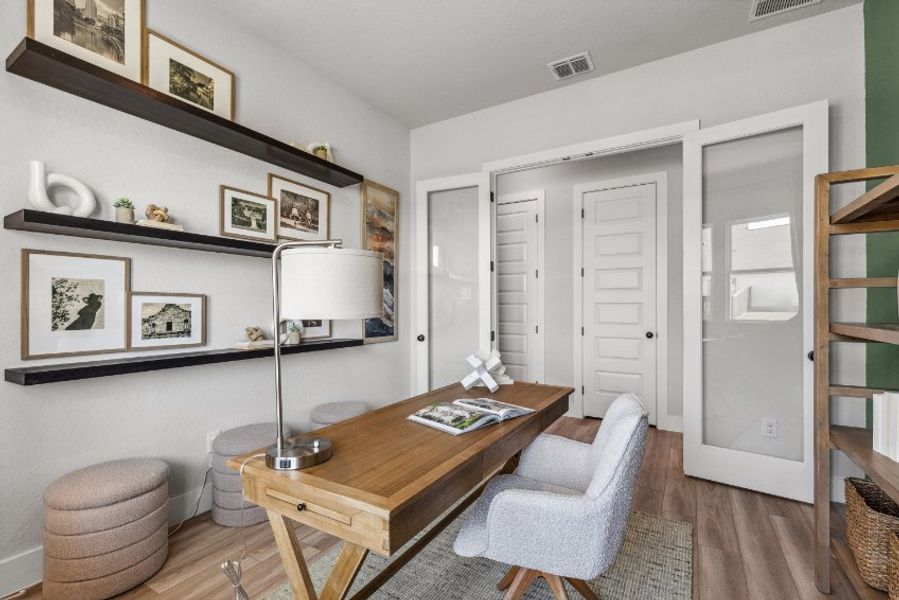 A living room with a table and chairs.