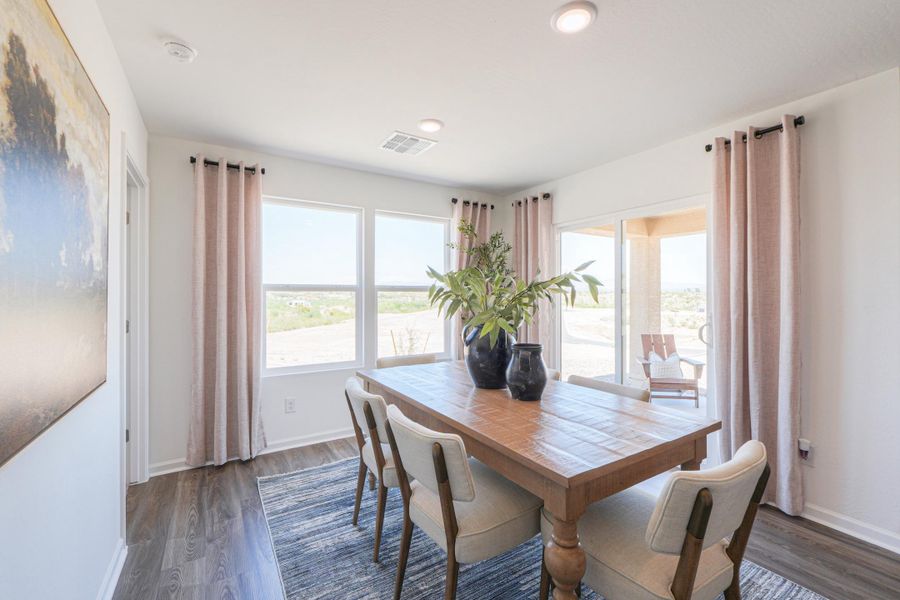 A dining room table with chairs.