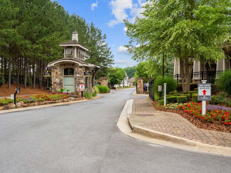 Entrance to the The Village at Towne Lake community in Woodstock, GA, featuring signage and landscaping (Image 16). Entrance to the The Village at Towne Lake community in Woodstock, GA, featuring signage and landscaping (Image 16).