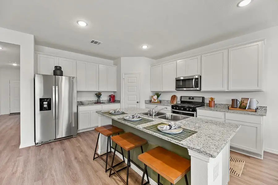 A kitchen with white cabinets. A kitchen with white cabinets.