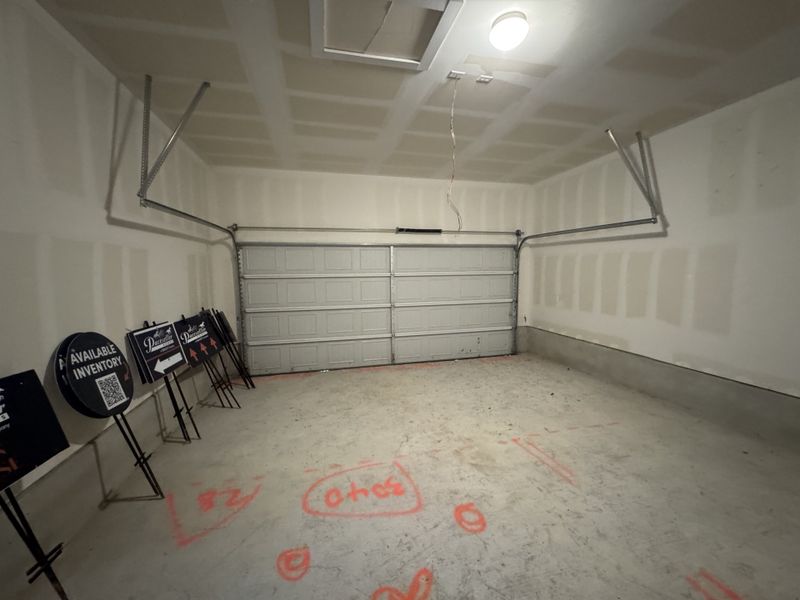 A spacious garage with a concrete floor and painted walls, ideal for storage or parking vehicles.