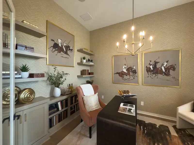 A sophisticated home office with chic art, elegant shelving, and modern lighting. A sophisticated home office with chic art, elegant shelving, and modern lighting.