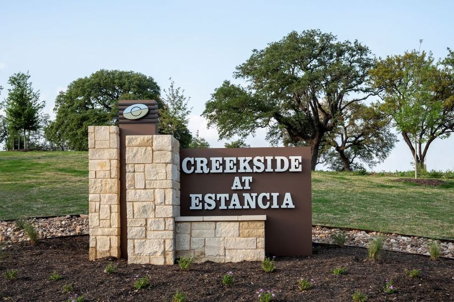 Entrance to the Creekside at Estancia community in Austin, TX, featuring signage and landscaping (Image 9). Entrance to the Creekside at Estancia community in Austin, TX, featuring signage and landscaping (Image 9).