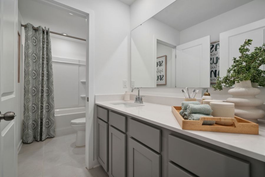 A bathroom with a tub sink and toilet. A bathroom with a tub sink and toilet.