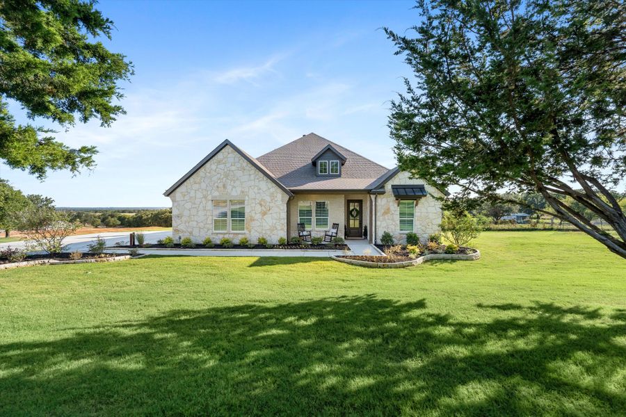 Front exterior of a home in the Oak Grove Addition community, located in Springtown, TX (Image 10).