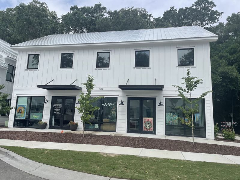A charming white building with black accents and large windows in Hayes Park by New Leaf Builders (Johns Island, SC). A charming white building with black accents and large windows in Hayes Park by New Leaf Builders (Johns Island, SC).