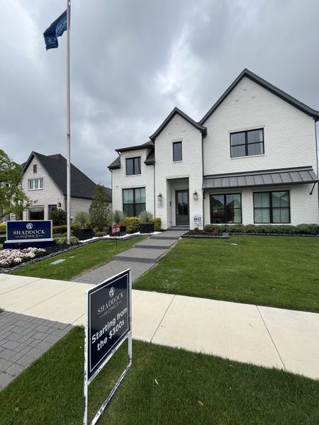 A striking white brick home with a lush lawn in Devonshire by Shaddock Homes, Forney, TX, offering elegance and charm. A striking white brick home with a lush lawn in Devonshire by Shaddock Homes, Forney, TX, offering elegance and charm.