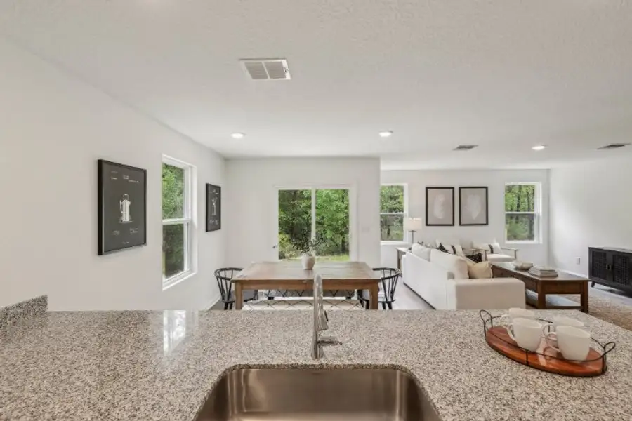 A living room with a large table and chairs. A living room with a large table and chairs.