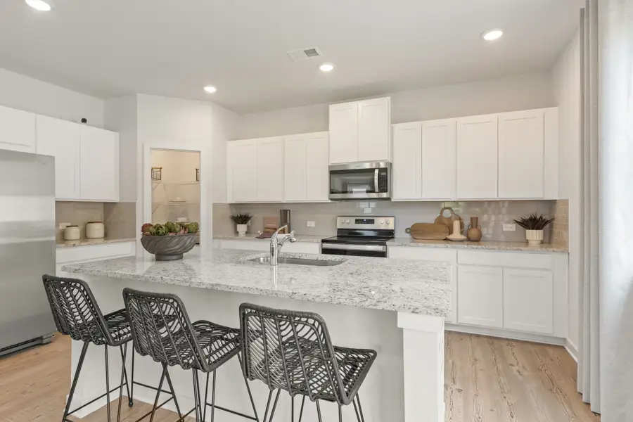 A kitchen with white cabinets. A kitchen with white cabinets.