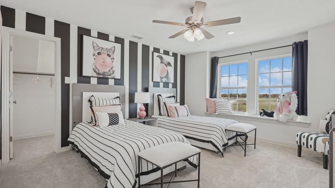 Twin bedroom boasts chic stripes, plush carpet, and artistic flair, epitomizing luxury in Bel Air Village.