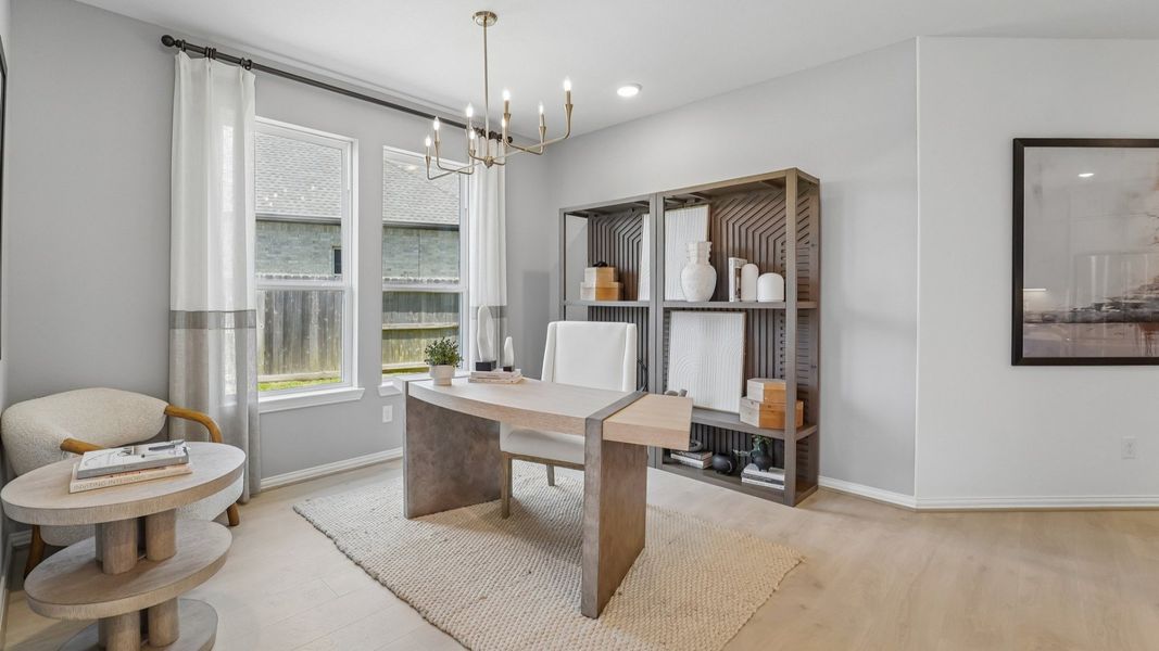 Luxurious office space with chic chandelier, expansive windows, and sleek shelving in The Woodlands Hills.
