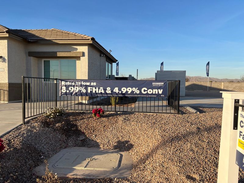 A modern home with a sleek facade and stone landscaping in Copper Falls by D.R. Horton (Buckeye, AZ).
