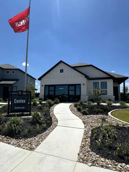 A modern home with landscaped path and garden in Dove Song by Centex (Santa Clara, TX).