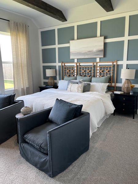 A cozy bedroom featuring a bold accent wall, elegant bedding, and plush seating with modern decor and natural light. A cozy bedroom featuring a bold accent wall, elegant bedding, and plush seating with modern decor and natural light.