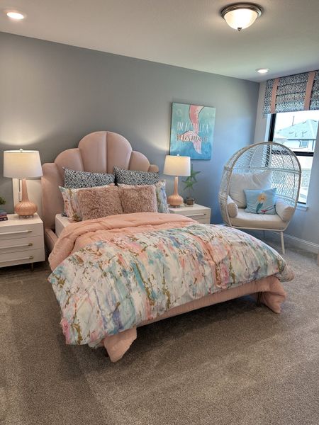 A cozy bedroom with a pastel bed, chic lamps, and a playful mermaid-themed decor. Stylish and inviting ambiance. A cozy bedroom with a pastel bed, chic lamps, and a playful mermaid-themed decor. Stylish and inviting ambiance.