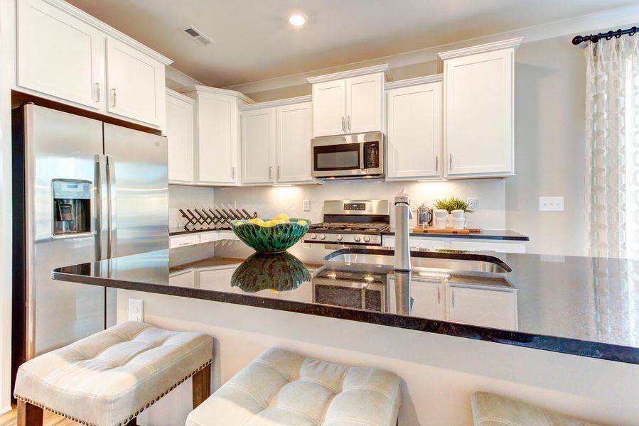 Furnished interior in a model home at 1158 Place Townhomes in Wilson (Image 3). Furnished interior in a model home at 1158 Place Townhomes in Wilson (Image 3).