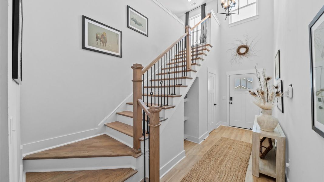 Stylish foyer with hardwood flooring and tasteful architectural detail in a superior layout at the Robert's Farm community